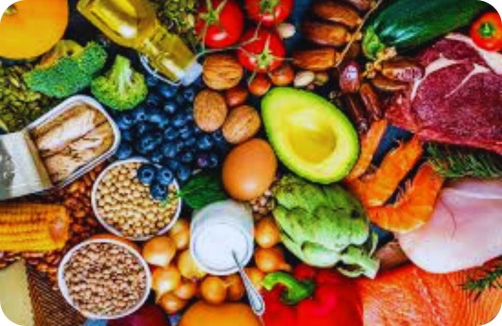 “Healthy balanced nutrition meal with vegetables, fruits, grains, and protein on a wooden table”